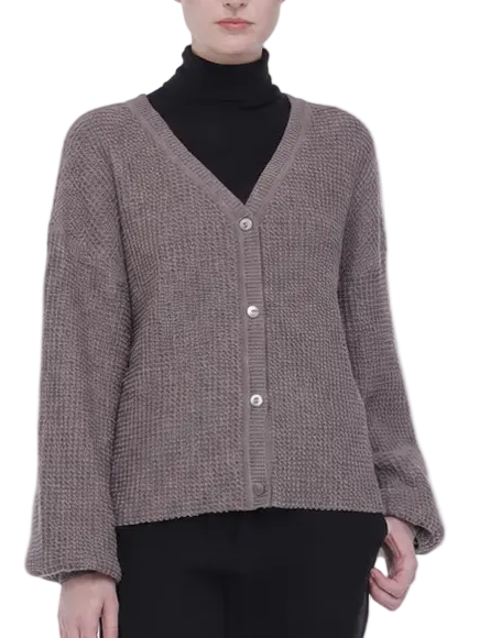 A model wearing a taupe-brown and black micro-check knit cardigan over a black turtleneck, paired with black trousers and brown leather loafers, shot against a solid white background.