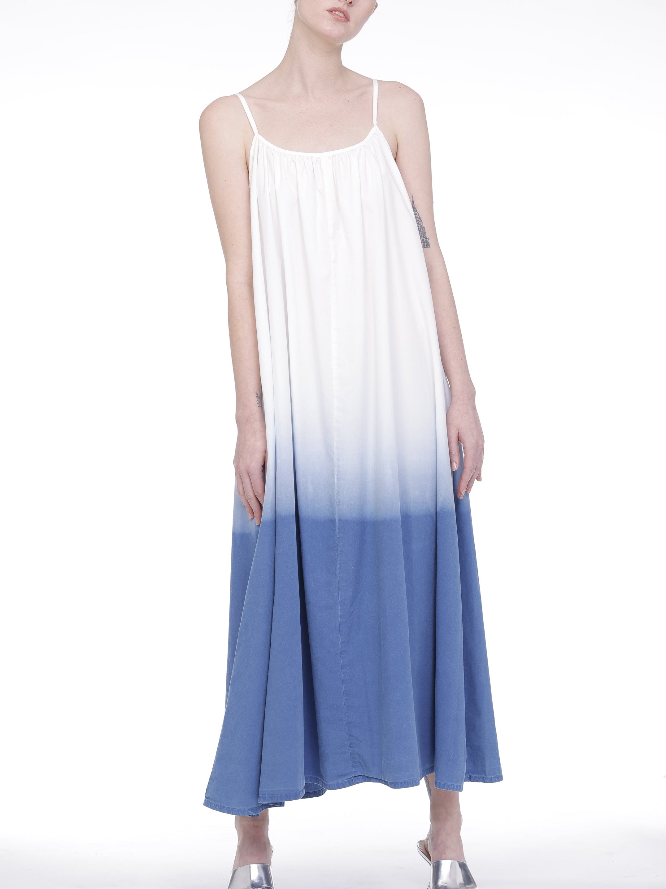 Woman wearing a blue and white gradient dress on a white background