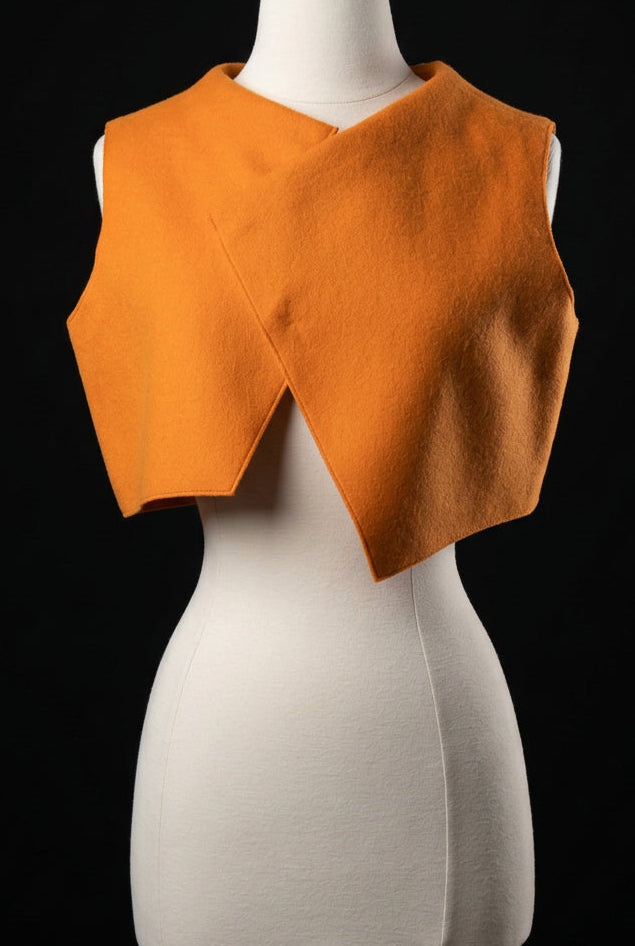 An orange sleeveless vest or cape-style top.